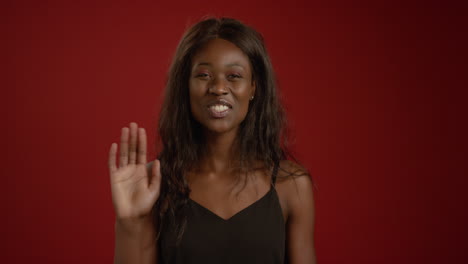 Woman-Laughs-and-Waves-at-Camera