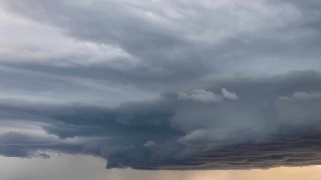 Ominous Layered Storm Clouds Over Horizon, Rolling Shelf Base With Low Hanging Wall Cloud, Heavy Gray