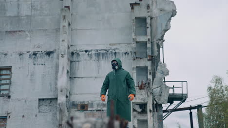 human in biohazard uniform standing in the empty city. man in protective mask and suit.