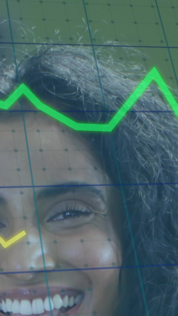 Animation of multiple graphs and grid pattern over smiling woman standing in office