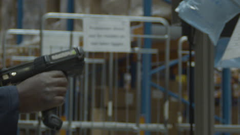 man using scan gun to scan shipping labels