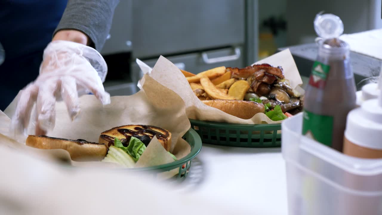Chef Prepares Delicious Burgers and Fries in an urban restaurant kitchen