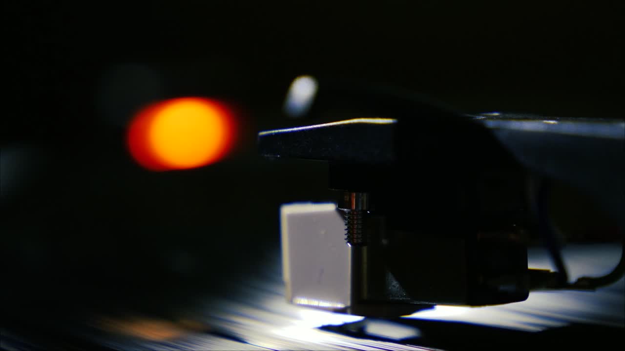 Closeup needle on spinning vintage vinyl record on turntable