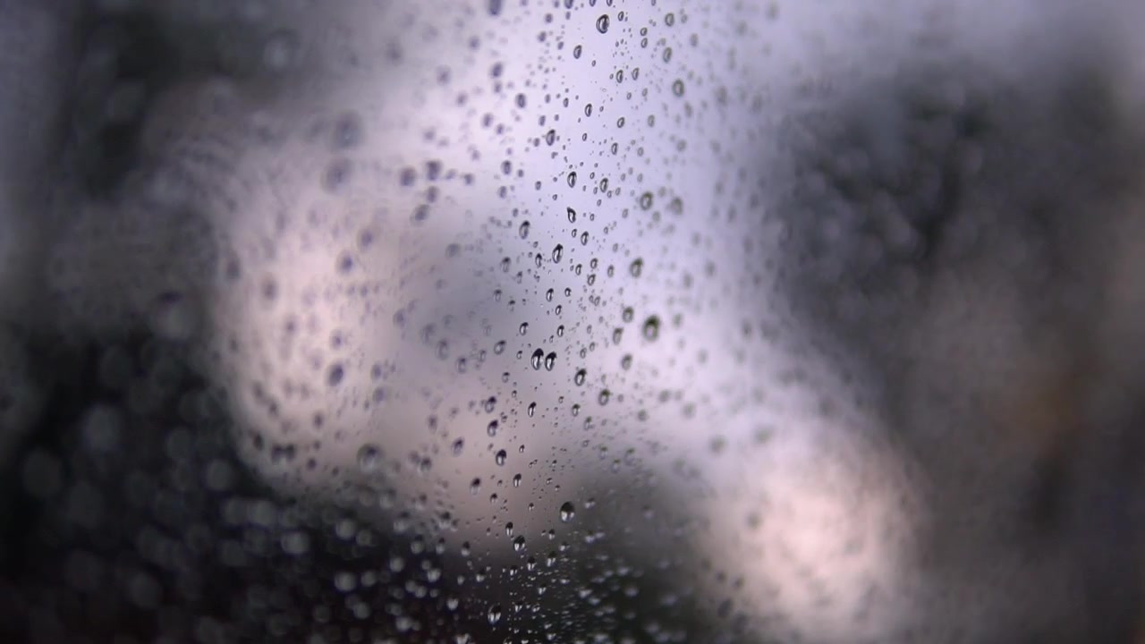 Rain drops on a glass on a Rainy day