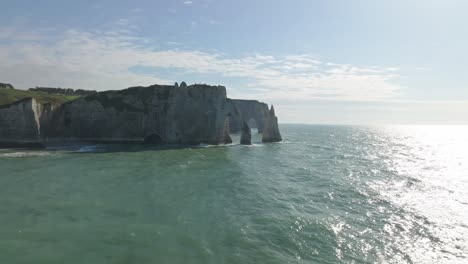 flying towards  the cliffs of etretat at sunset