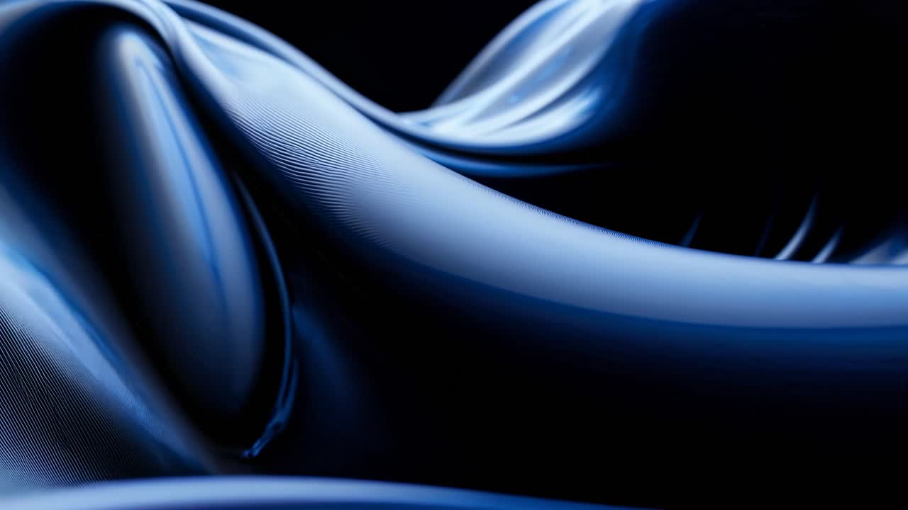 Abstract video concept with a close-up, low-angle view of smooth, flowing blue curves