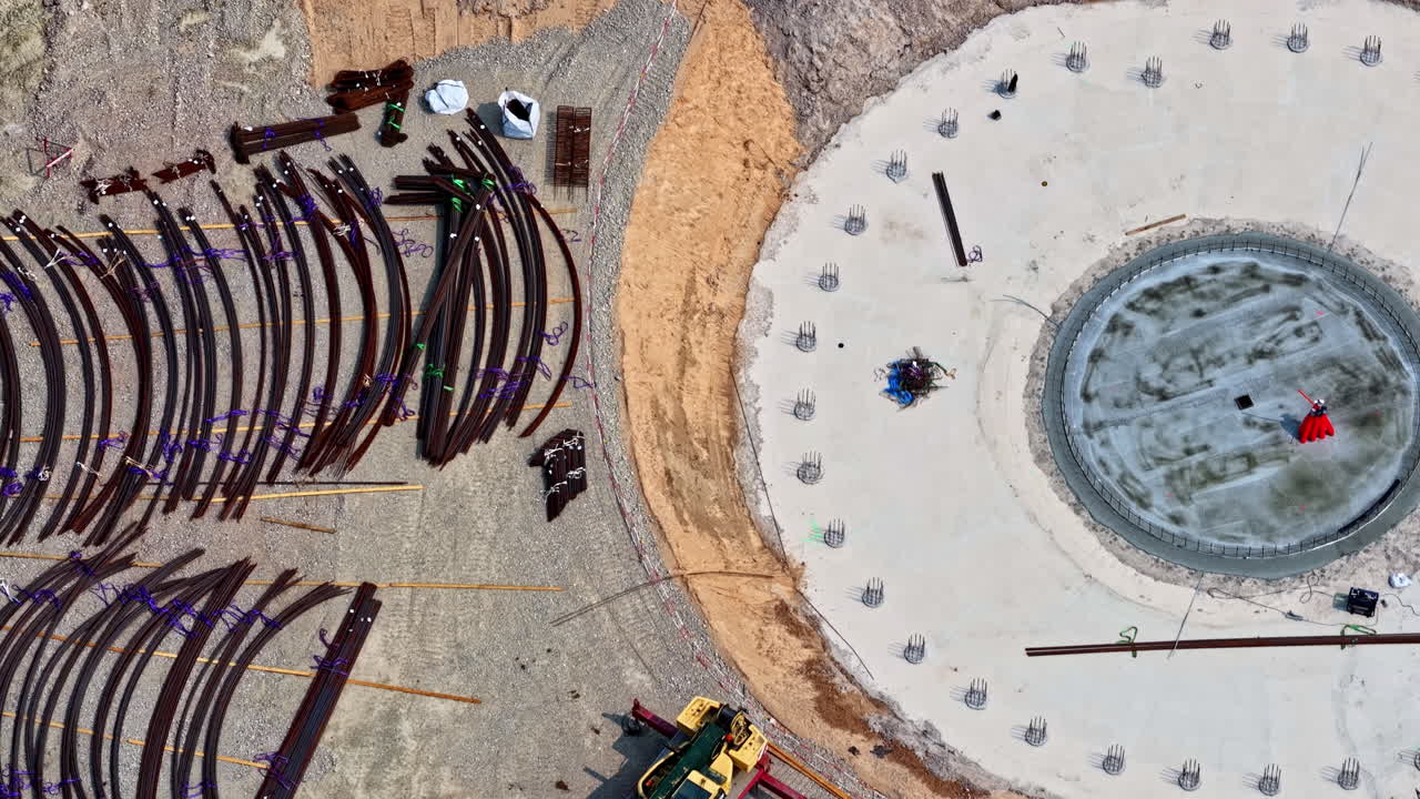 Wind turbine foundation surrounded by steel beams and concrete platform under construction