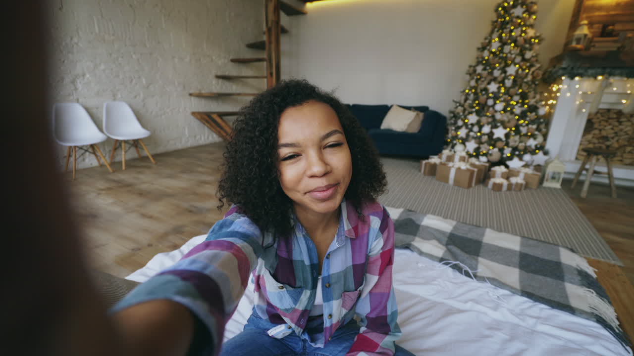 Young Woman Taking a Selfie in a Cozy Christmas Living Room