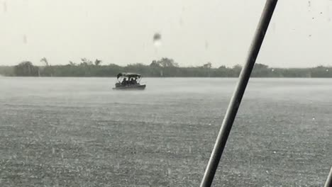 Local-fishermen-brave-a-heavy-rain-storm-on-the-Chobe-River,-Botswana