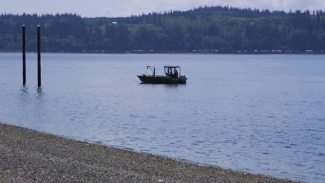 small, nondescript fishing floating near dock at camano island state park, wa state