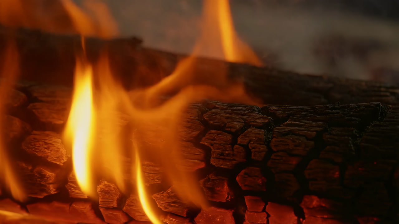 Closeup Dancing Flames Along Cracked Log, Taller Vertical Tongues And Hot Coals Produce Intense Crackle