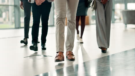 business people walking in office corridor