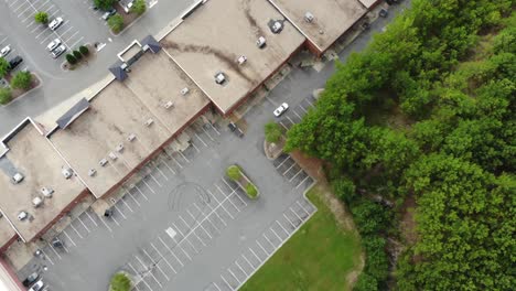 Aerial-tracking-follow-police-car-behind-shopping-center