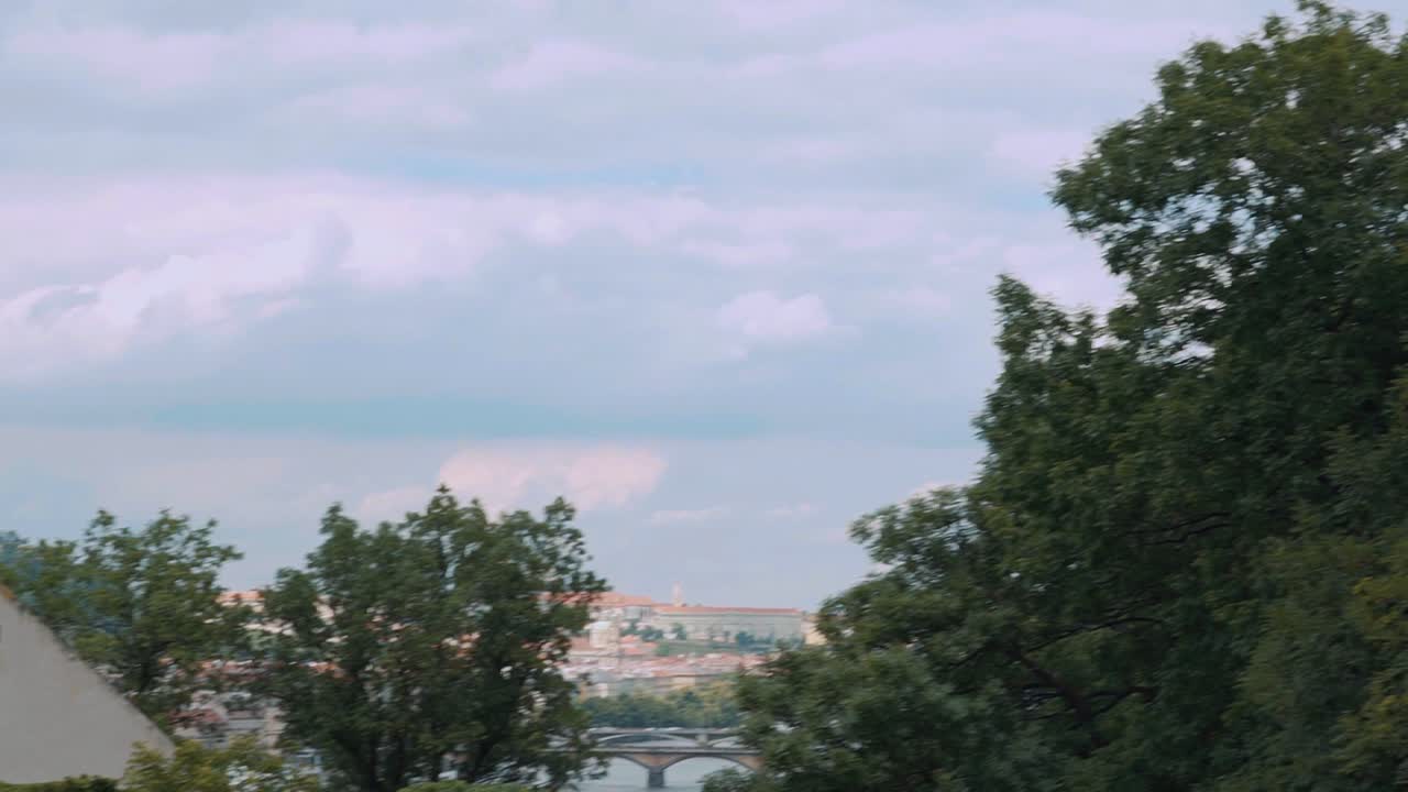 Spires Of St. Vitus Cathedral Near Vltava River In Prague, Czech Republic. tilt down, panning shot