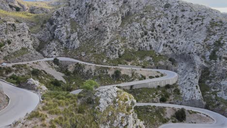 revealing shot of hairpin bends on a mountain road at sa calobra, mallorca, spain