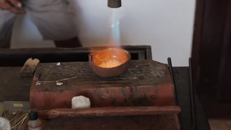 traditional silver forge melting with blow torch