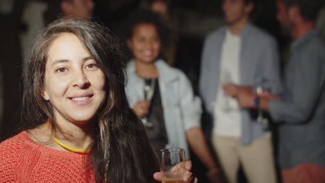 Cheerful-woman-looking-at-camera-and-drinking-champagne