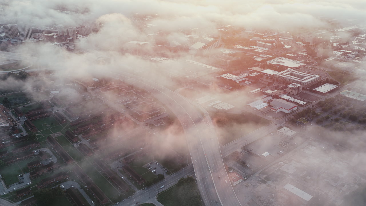 Dense morning fog blankets Chattanooga’s roads and neighborhoods, softening the city’s industrial grid.