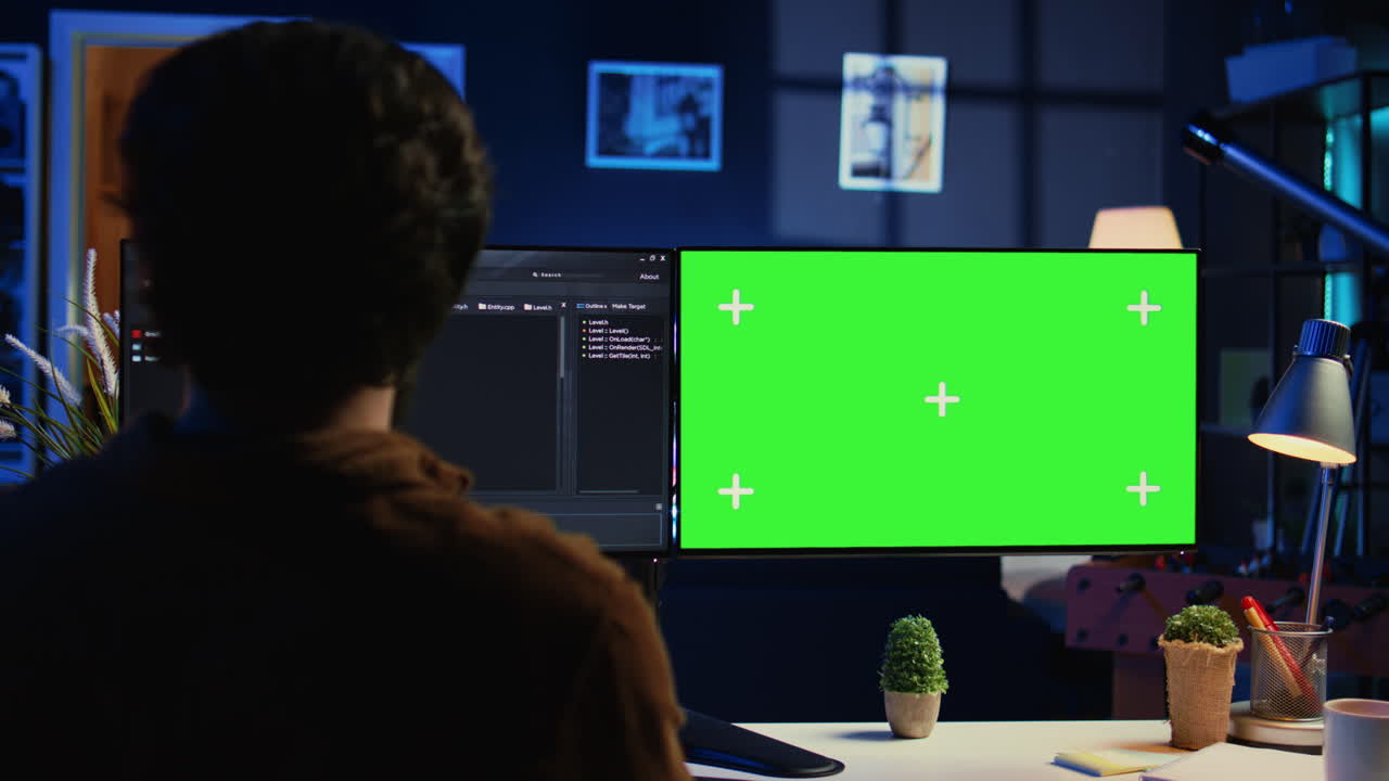 Software programmer writing lines of code on chroma key computer at home
