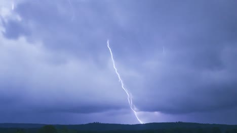 dramatic stormy sky with bright lightning bolts illuminating rural hills. captures the power and beauty of natural thunderstorms