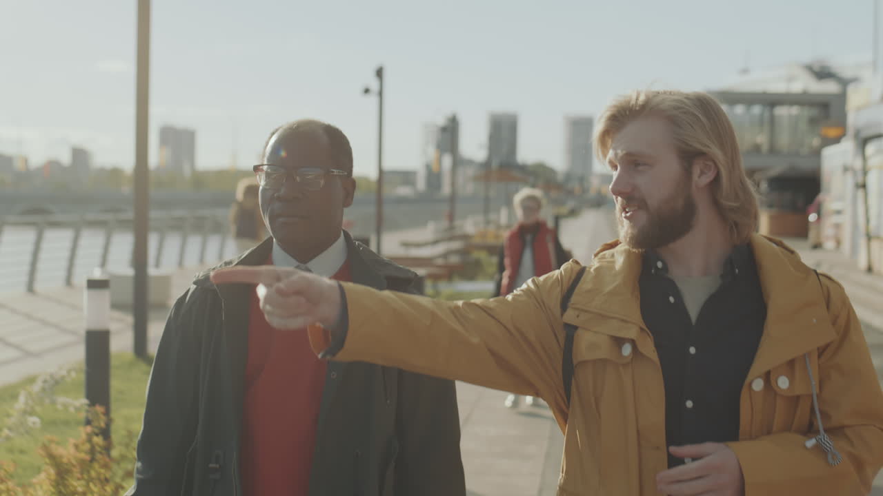 Multiethnic Friends Walking in City and Having Talk