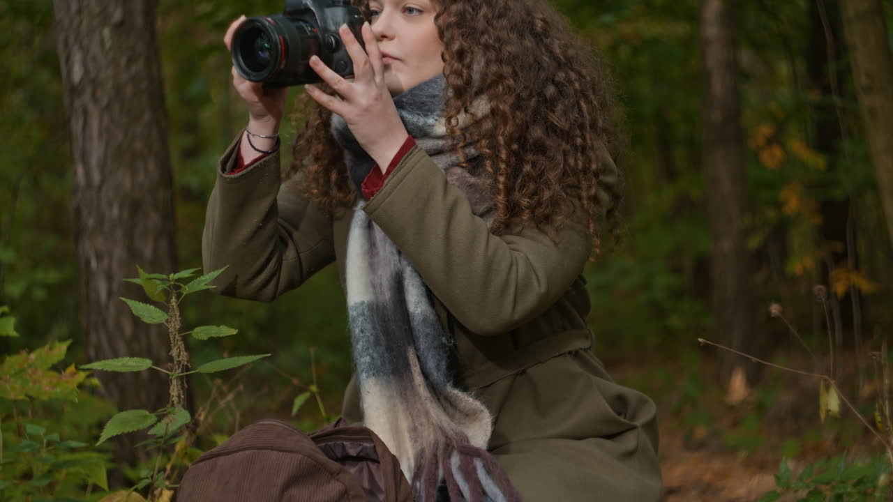Woman with Camera in Autumn Forest