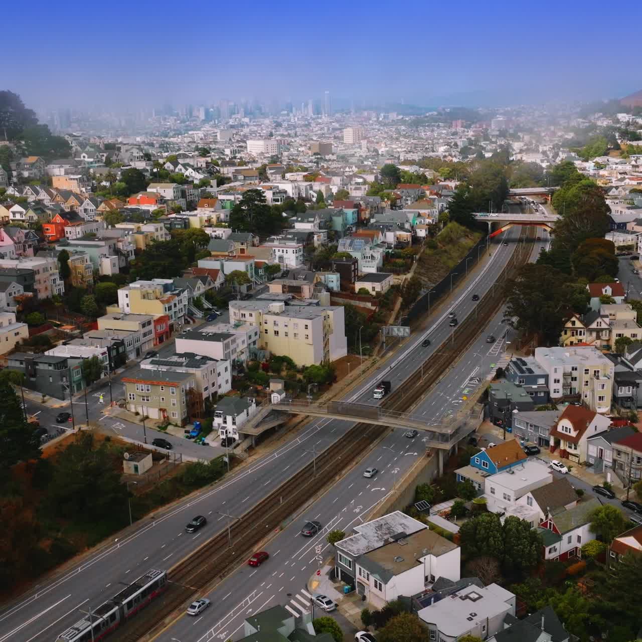 Sunny city with beautiful architecture at daytime. Transport moving by the motorways. Aerial perspective