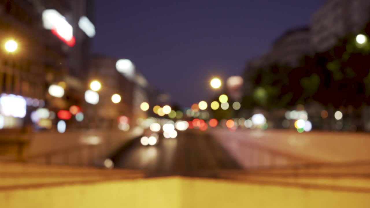 ciudad de noche con autos que entran en un túnel desenfocado
