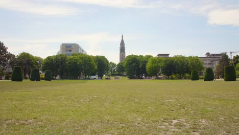 Cityscape-with-big-lawn-and-green-grass,-low-perspective