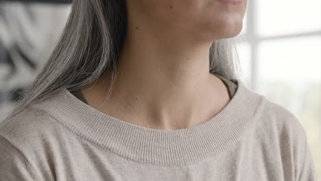 close up of a woman having throat pain and touching her neck