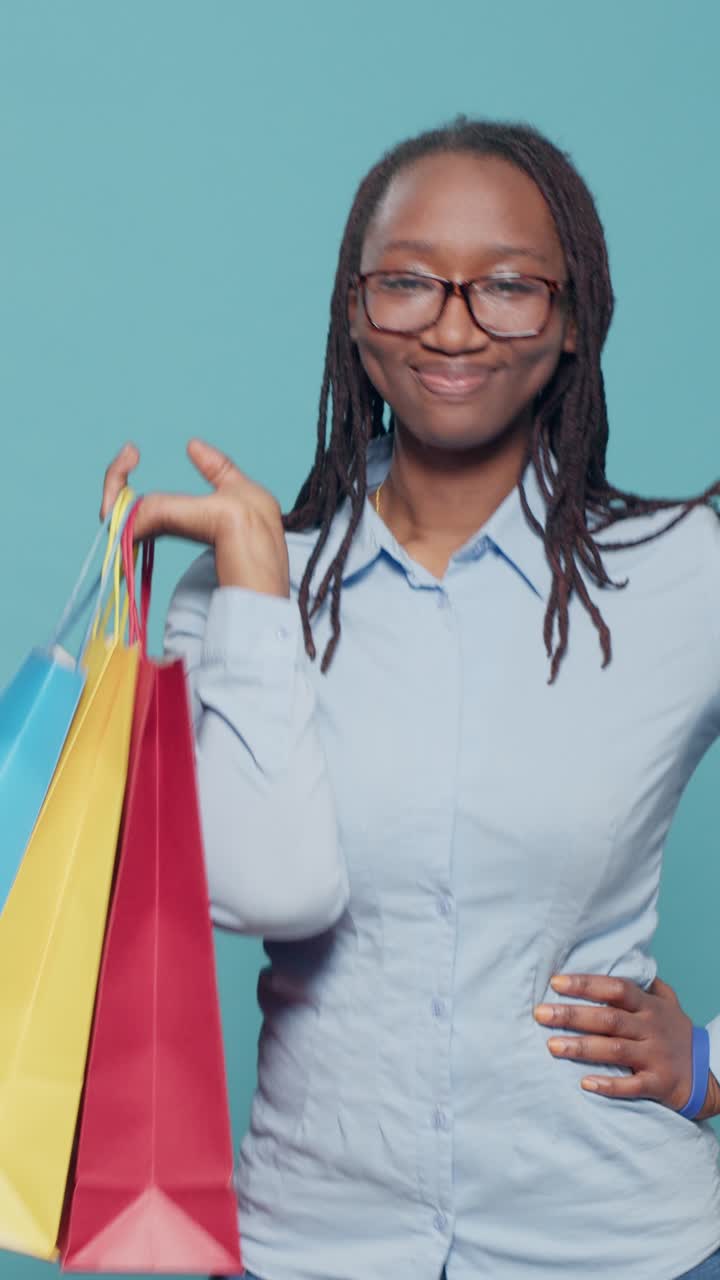 Joyeuse femme afro-américaine avec des sacs de shopping