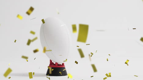 animation of confetti over white rugby ball on white background