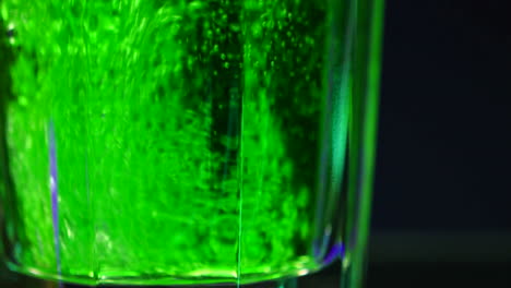 vibrant green drink in a shot glass