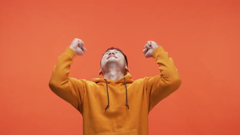 happy man in orange hoodie