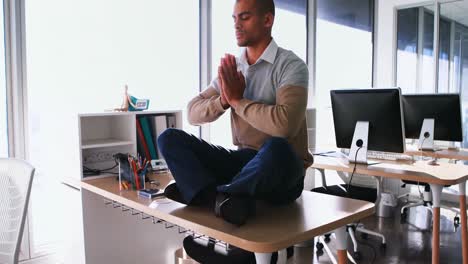 male executive doing yoga in office 4k