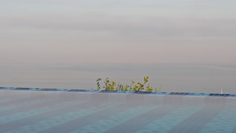 rooftop pool looking down over kuta beach in bali at sunrise