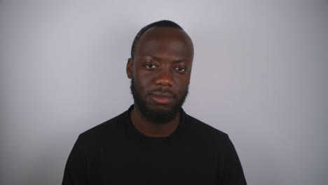 black male listening to music with white background