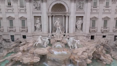the trevi fountain, one of the most famous monuments in rome, italy. descending aerial shot.