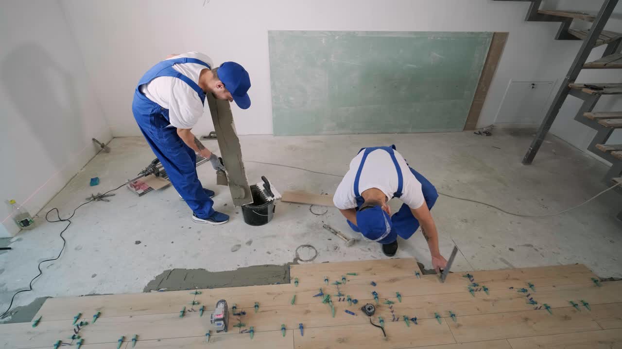 Installing ceramic floor tiles - measuring and cutting the pieces. Construction, renovation, repair apartment. Cuts tile. Tile cutting
