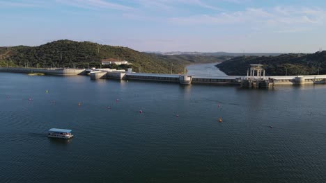Drone-flying-over-Alqueva-dam-with-river-in-background,-Portugal