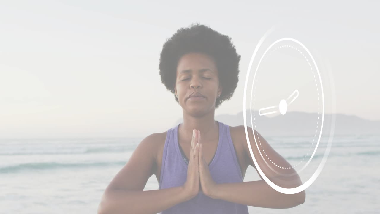 mid age woman lifting hands into yoga meditation dawn beach showing circular timer counting breath