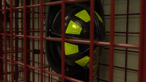 firefighter helmet hangs in a locker at a fire station