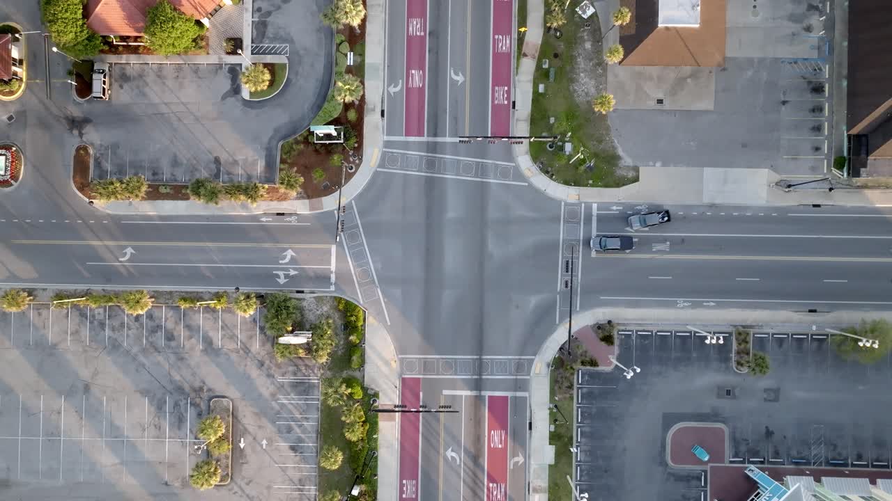 Traffic at an intersection in Panama City Beach, Florida with drone video overhead and looking down.