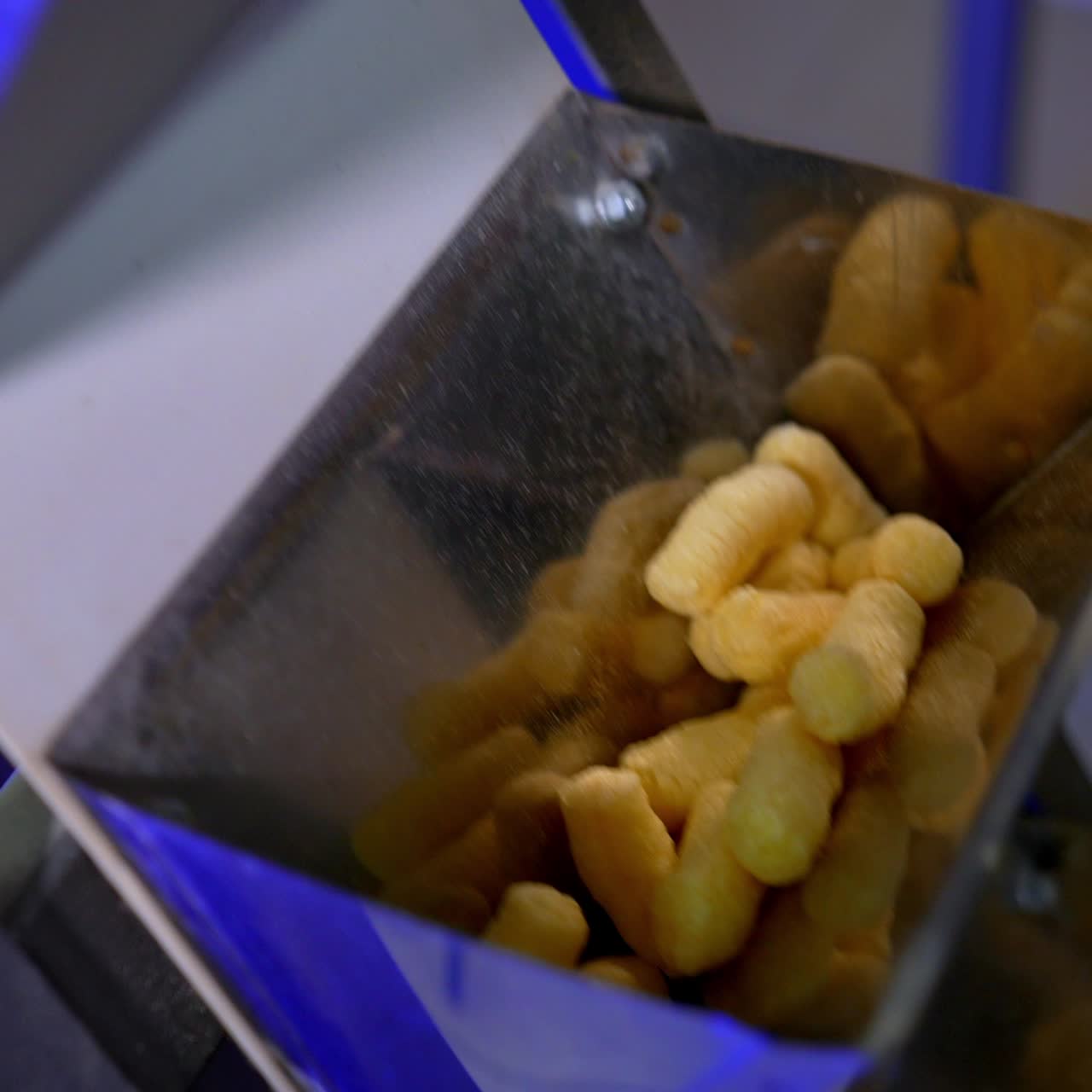Snacks of corn making for kids. Sticks of corn making in the factory