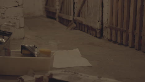 discarded items and debris on a basement floor