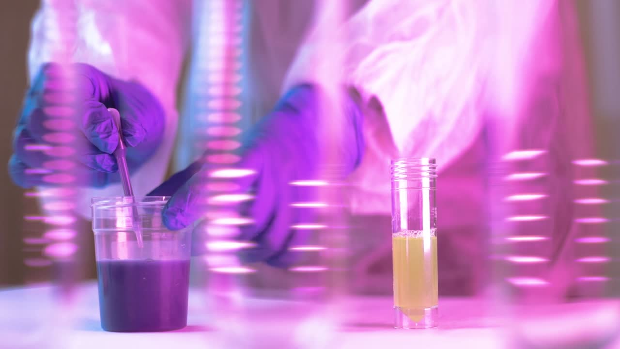 Hands of scientist wearing plastic gloves carefully filling the solution from the glass tubes for Coronavirus analysis