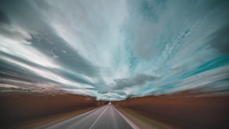 hyperlapse driving through the windswept autumn tundra, with dark clouds swirling above the road