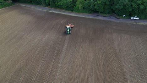 static aerial shot of a farmer plowing his field