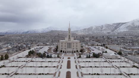 payson utah temple in snowy landscape. aerial forward