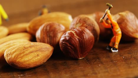 Close-up-of-figurine-with-hammer-and-dried-fruits